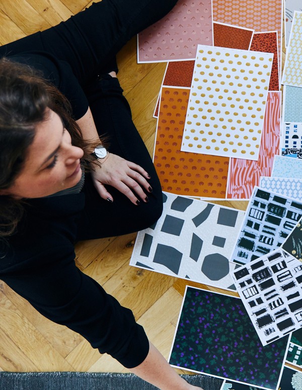 Nina sitting with several fabric samples